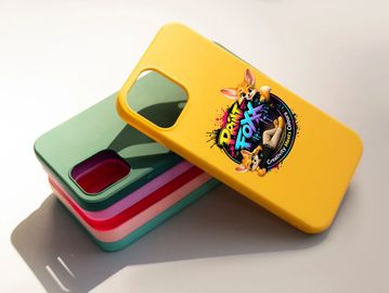 Colorful phone cases stacked, with a yellow one featuring a vibrant cartoon design.