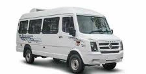 White Force Motors Tempo Traveller van with tinted windows and sliding door.