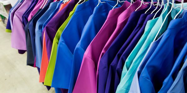 Picture of bright colored clothes on hangers