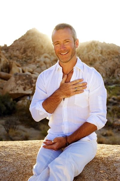 man with hand over heart in sun