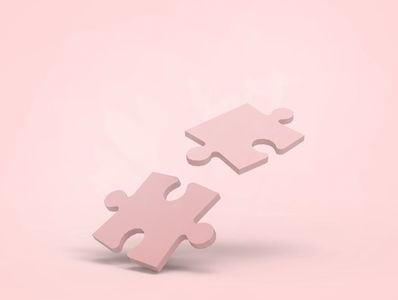 Two pink puzzle pieces floating on a pink background.
