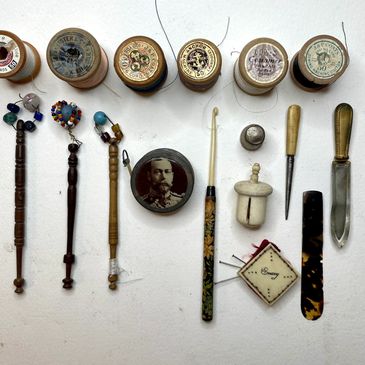 A selection of amazing finds - George V tape measure, crochet hook, lace making tools, wooden cotton