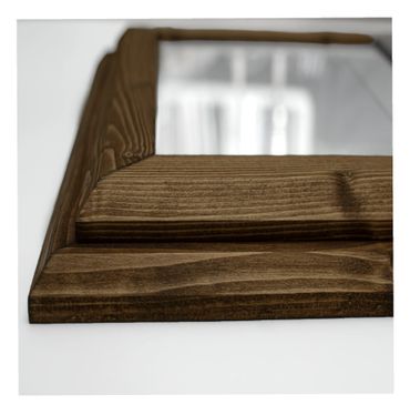 A thick quality wood picture frame up close.