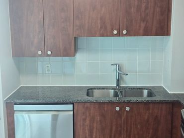 Kitchen countertop and backsplash sealed with fresh caulking.
