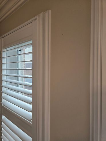 Close-up of interior window trim with smooth white caulking