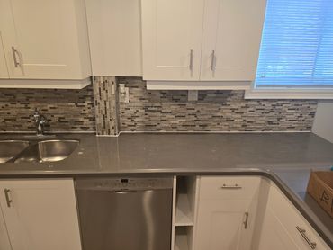 Kitchen countertop and backsplash with clean caulking lines along edges