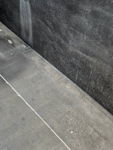 Clean caulking line sealing the joint between a shower base and wall panel for a watertight finish.