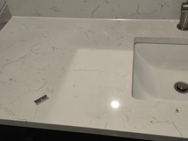 Bathroom vanity countertop with neat caulking along backsplash and sink edge