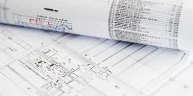 Close-up of architectural blueprints with technical drawings and annotations.