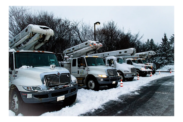 bucket trucks lined up snow