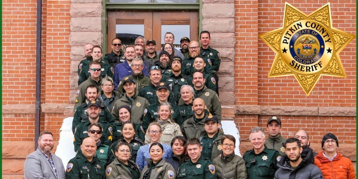 sheriff's office employees on posing for photo on steps of courthouse