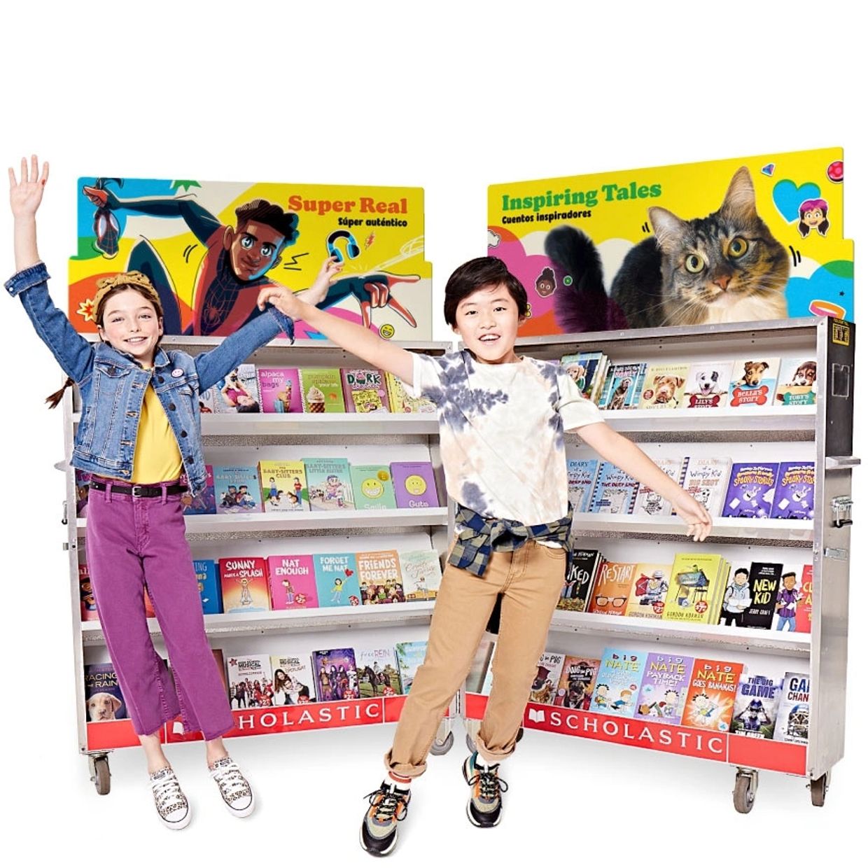 Two happy children jumping in front of a Scholastic book display.