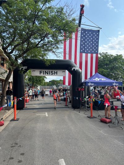 Runner crossing the finish line at a race event.