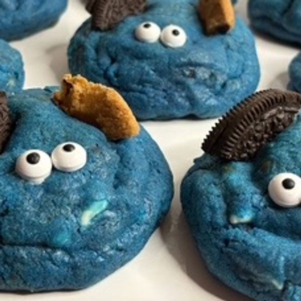 Blue cookies with candy eyes and cookie pieces.