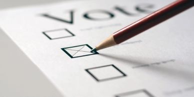 A sample ballot being marked by a pencil.