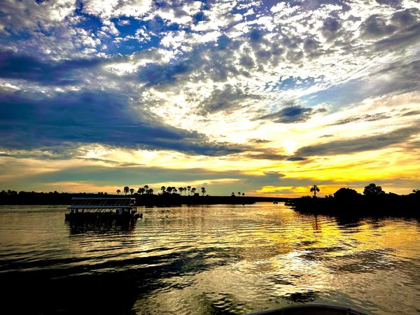 Boat tour with sunset overlooking Zambezi river on private tour in Zimbabwe