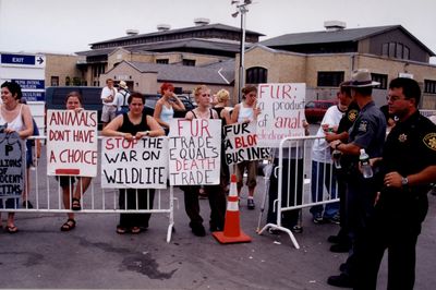 Animal rights activists protesting outside a trapping convention.