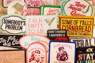 A collection of colorful humorous patches with various sayings and designs.