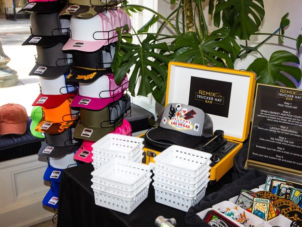 Colorful trucker hats and patches at a Remix Trucker Hat Bar display.