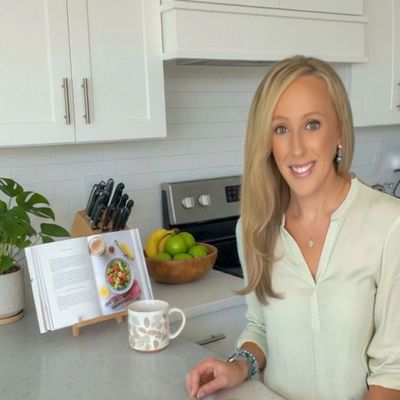Woman preparing fresh vegetables in a bright kitchen.