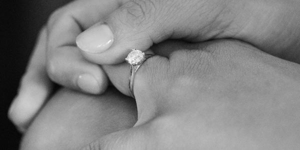 Hand with engagement ring.