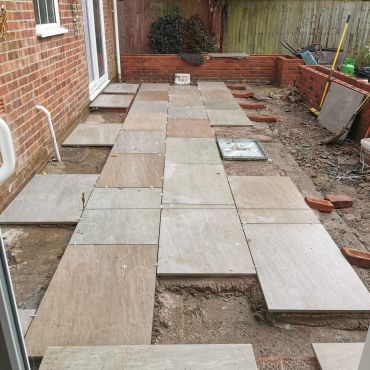 Outdoor tiled patio under construction.
