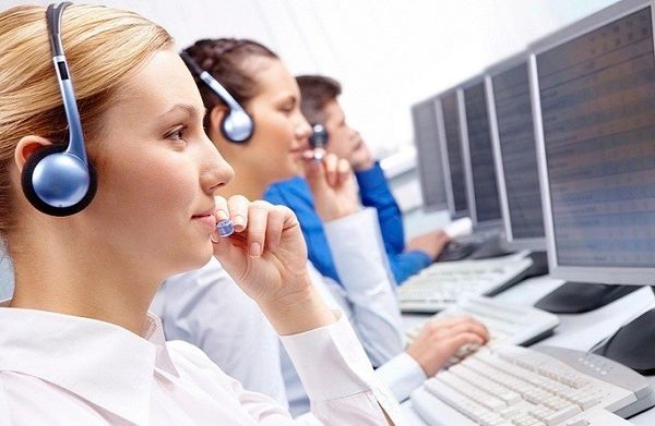 People talking on the telephone at computers