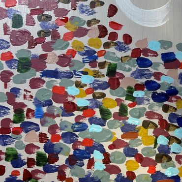 Quantum entanglement a close up image of a work by Angus Fraser, multi coloured dots on grey