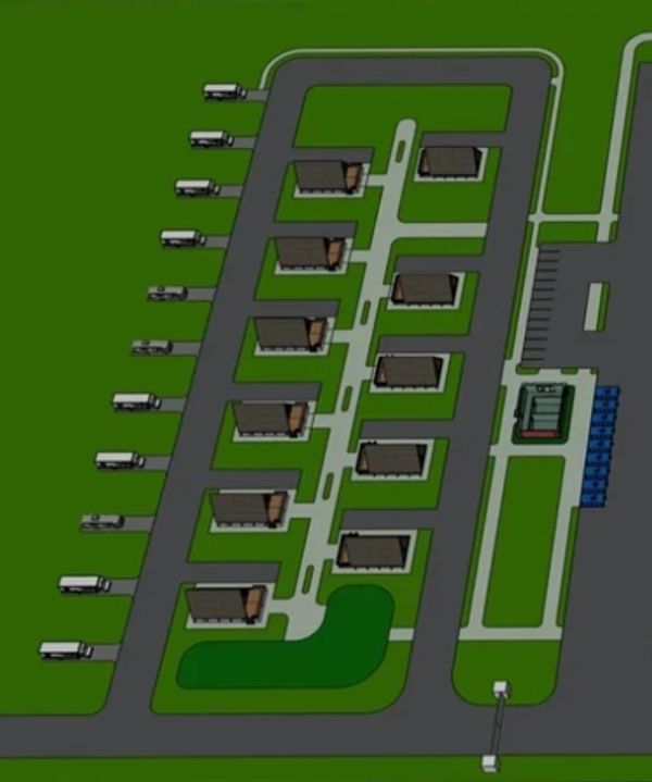 Aerial view of a small warehouse complex with trucks parked outside.