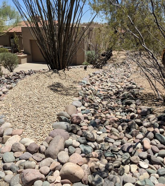 River rock used to create a dry river bed and as curb side edging.