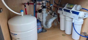 Under-sink reverse osmosis system with storage tank installed by Pure Life H2O