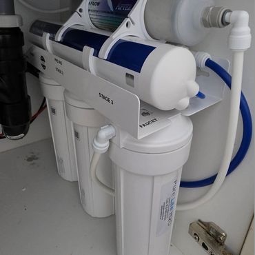 Alkaline Reverse osmosis drinking water system installed under a kitchen sink by Pure Life H2O
