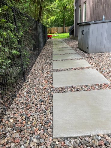 poured concrete patio stones and chain link fence 