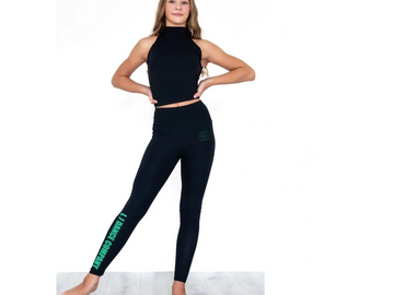 Young girl in a black sleeveless top and leggings posing confidently.