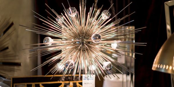 Modern starburst chandelier with glass orbs.