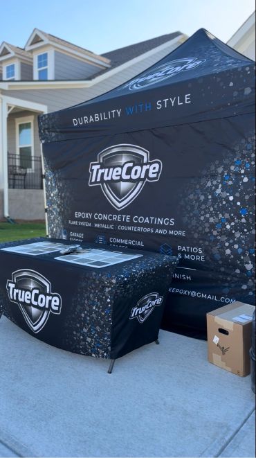 TrueCore epoxy concrete coatings promotional setup outdoors.