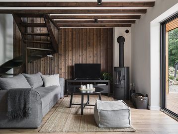 Cozy living room with wooden accents and modern fireplace.