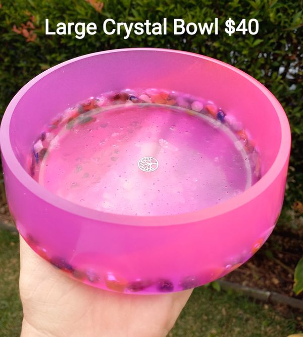 A vibrant pink crystal bowl with embedded colorful stones, priced at $40.