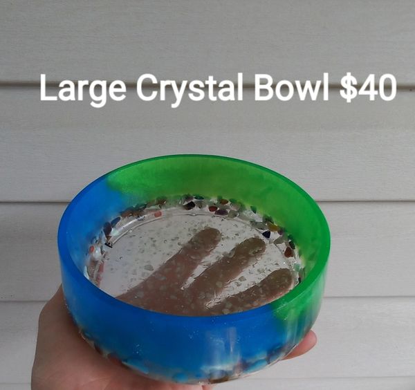 Hand holding a large blue and green crystal bowl priced at $40.
