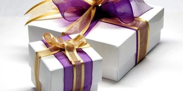 Gift box with purple and gold ribbon