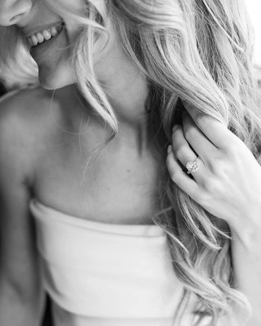 Bride smiling with long curled hair.