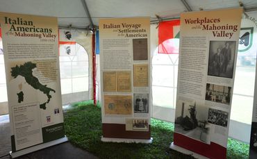 Tall poster boards of Italian history in the Coulter tent