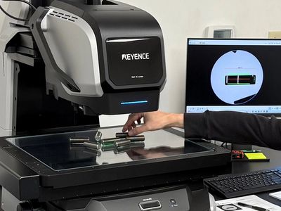 Man using a Keyence IM-X series measuring machine.