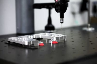 Precision measuring instrument inspecting a metal part.