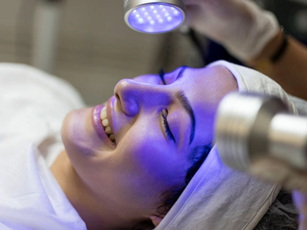 Woman undergoing BLUE LIGHT THERAPY TREATMENT FOR ACNE