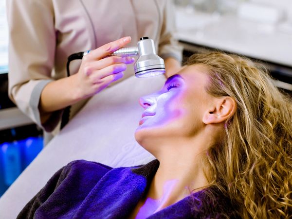 Woman undergoing BLUE LIGHT THERAPY TREATMENT FOR ACNE