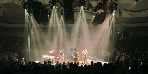 Concert venue in the round with flown PA and lighting on a circular truss