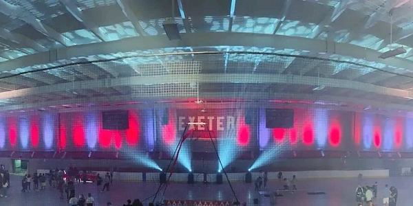 Uplighting and moving lights in an indoor ice rink at a school
