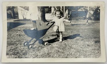 A child with a toy stroller.