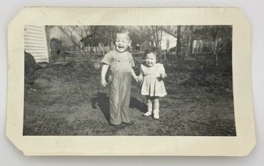 Two children holding hands.